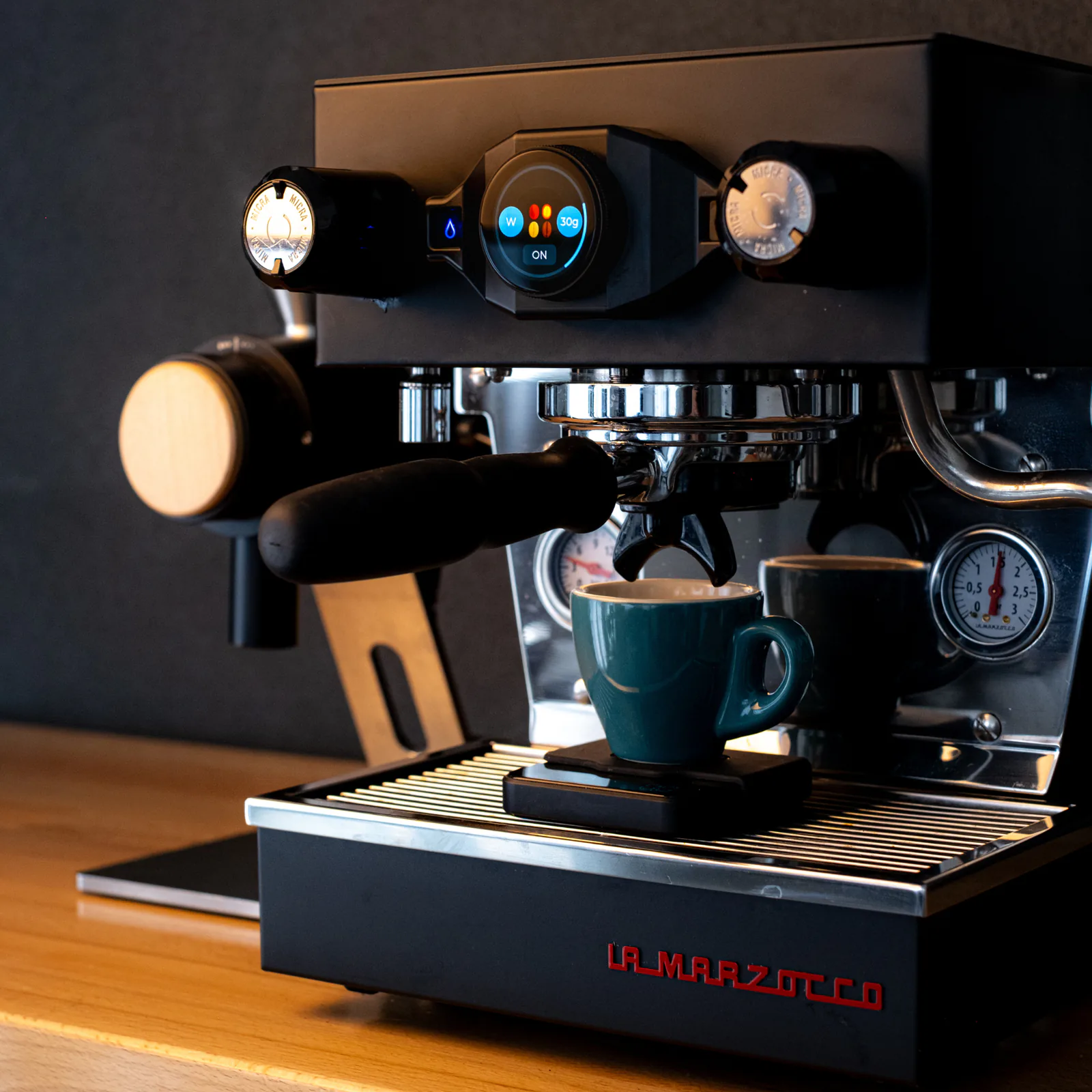Espresso brewing into a teal cup on the Linea Micra